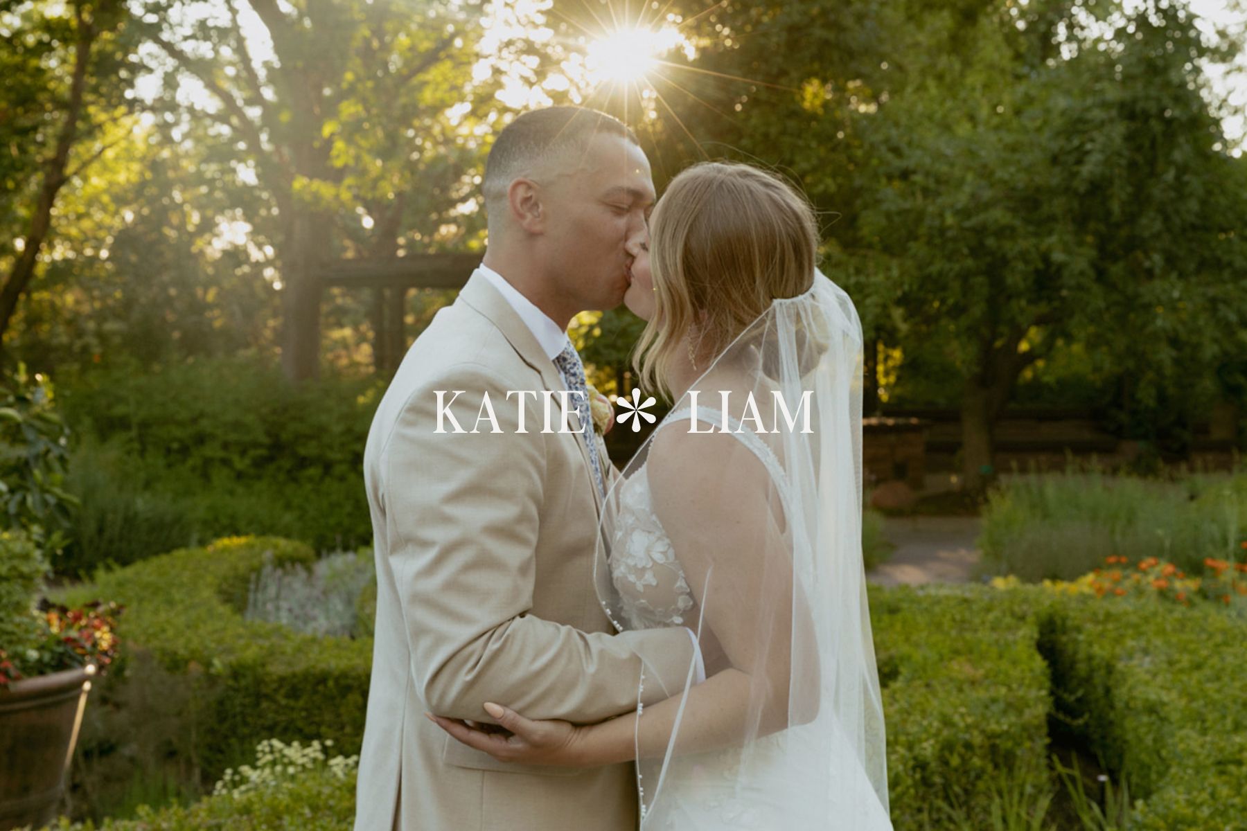 Couple kissing in a garden on their wedding day