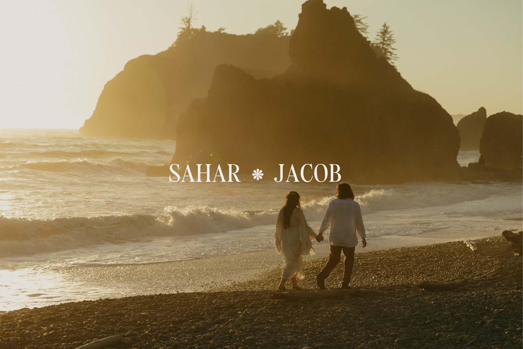 Olympic National Park elopement couple walking on Ruby Beach at sunset with sea stacks in the background.